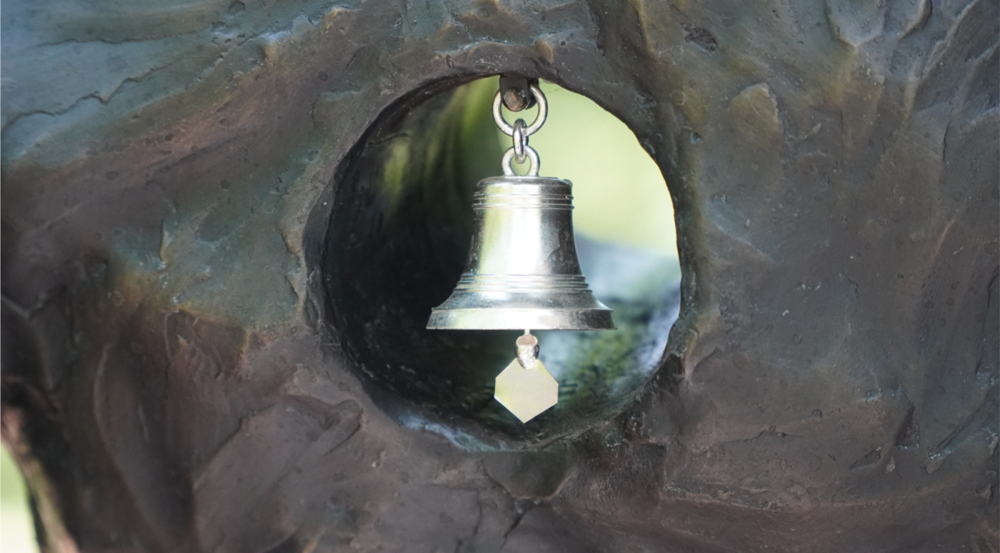 close up of bell on statue
