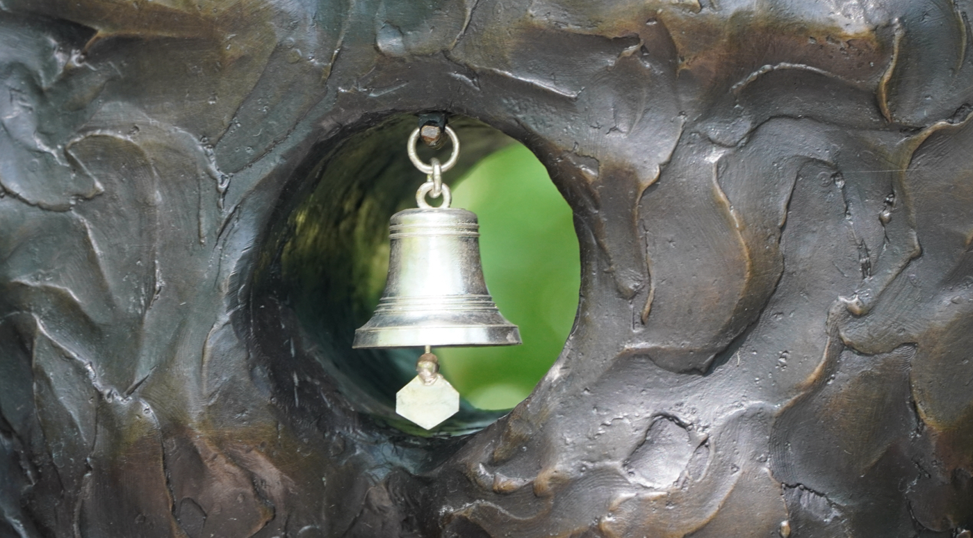 close up of bell on statue